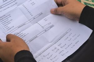 Peserta Lomba Melamun membawa slip gaji sebagai bahan melamun. Setiap bulan ia harus mencicip Rp1 juta atau setengah dari gajinya untuk KUR BRI yang dipinjam orang tuanya MOJOK.CO