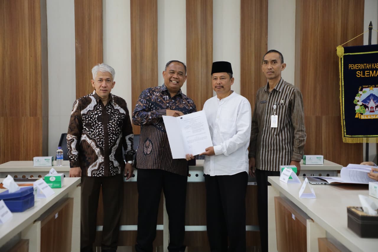 Bupati Sleman, Harda Kiswaya menyerahkan hibah secara simbolis ke ormas dan tempat ibadah MOJOK.CO